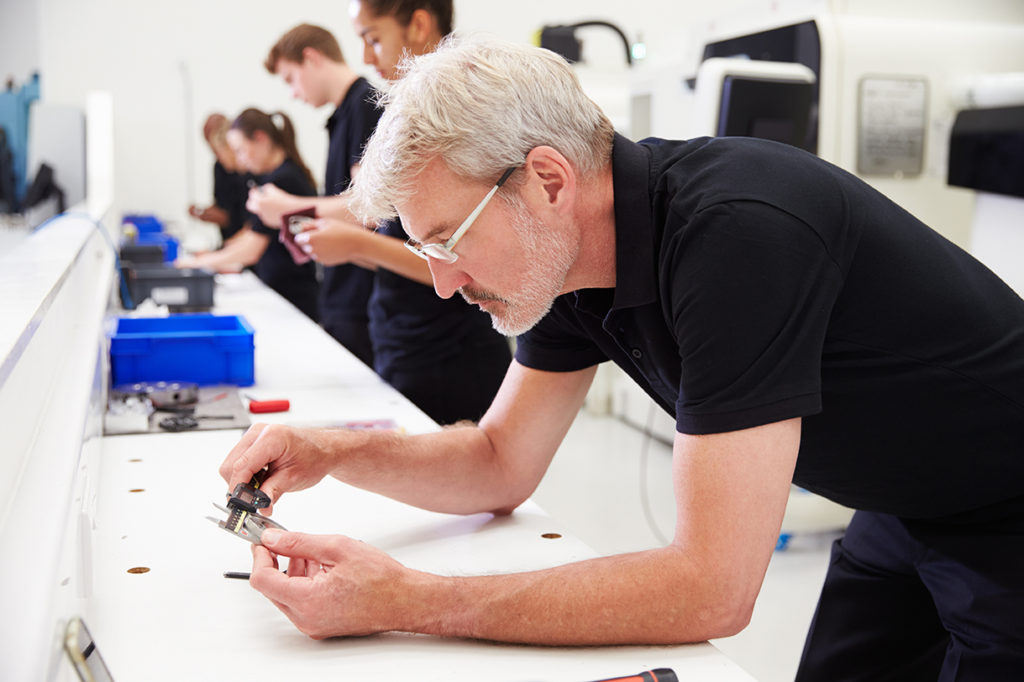 workers assemble security camera systems